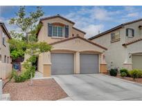 Charming two-story home featuring a spacious two-car garage and well-maintained landscaping under a sunny sky at 2431 Lilac Cove St, Las Vegas, NV 89135