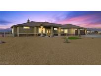 Charming single story home featuring desert landscaping and a welcoming double door entry at 3600 E Bridger St, Pahrump, NV 89061