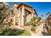 Charming two-story home featuring desert landscaping and a red tile roof against a bright blue sky at 4083 Nook Way # D, Las Vegas, NV 89103