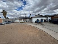 Modest single-story home with a sparse front yard, solar panels, and a long driveway at 5128 Wilbur St, Las Vegas, NV 89119