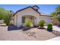 Charming single-story home featuring desert landscaping and a covered front porch at 5240 Adorato Dr, North Las Vegas, NV 89031