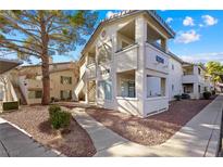 Charming condo exterior with walkways, private patios, and desert landscaping in a well-maintained community at 5259 Caspian Springs Dr # 204, Las Vegas, NV 89120