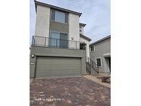 Beautiful two-story home featuring a two-car garage and an upper balcony with a modern, sleek design at 5748 Avondale Rise Way, Las Vegas, NV 89141