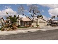 Charming single-story home featuring a two-car garage, desert landscaping, and a well-maintained front yard at 6440 Break Point Ave, Las Vegas, NV 89130