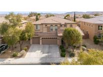 Two-story home featuring a three-car garage, neutral color scheme, and manicured landscaping in a suburban setting at 8425 Cambrils Ave, Las Vegas, NV 89178