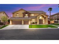 Attractive two-story home with a three-car garage and a well-manicured lawn at 9011 Tierra Santa Ave, Las Vegas, NV 89129