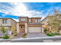 Two-story tan home features a two-car garage and low maintenance desert landscaping at 12397 Foxtail Run Ave, Las Vegas, NV 89138