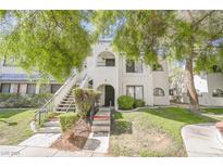 Charming two-story condo with well-maintained landscaping and stairs leading to the upper-level entrance at 1406 Santa Margarita St # H, Las Vegas, NV 89146