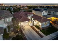 Stunning aerial view of a luxurious home featuring a tile roof and a well-manicured front yard in a desirable neighborhood at 2080 Orchard Mist St, Las Vegas, NV 89135