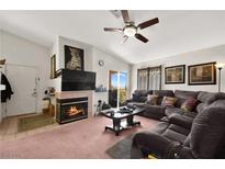 Cozy living room with a fireplace and comfortable sectional couch at 2110 Los Feliz St # 2075, Las Vegas, NV 89156