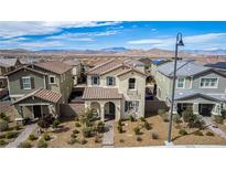 Charming two-story home featuring a tile roof, stone accents, and manicured landscaping in a suburban neighborhood at 2475 Piacenza Pl, Henderson, NV 89044