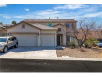 Charming two-story home featuring a desert landscape and attached two-car garage at 3215 Lubec Valley Ln, Henderson, NV 89074
