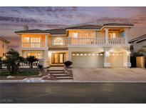 Two-story home with a three-car garage, tile roof, and manicured landscaping at 4384 Grey Spencer Dr, Las Vegas, NV 89141