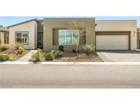 Modern home featuring a desert landscaped front yard and a two car garage at 4772 Se Argent Hills Ave, Pahrump, NV 89061