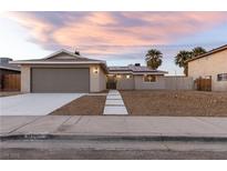 Charming single-story home with a two-car garage, desert landscaping, and freshly poured concrete walkway at 4842 Plata Del Sol Dr, Las Vegas, NV 89121