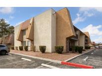 Condo with desert landscaping, stucco, and parking in front of units under a partly cloudy sky at 5180 Indian River Dr # 355, Las Vegas, NV 89103