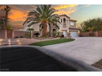 Elegant two-story home with a spacious driveway, well-manicured landscaping, and attached two car garage at 6214 Ebony Legends Ave, Las Vegas, NV 89131