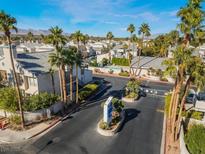 Scenic community entrance featuring mature palm trees, lush landscaping, and well-maintained buildings at 6250 W Flamingo Rd # 28, Las Vegas, NV 89103