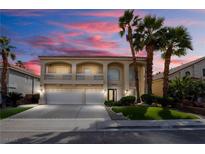 Stunning two-story home with a three-car garage and a charming balcony overlooking the well-manicured front yard at 6727 Enchanted Cove Ct, Las Vegas, NV 89139