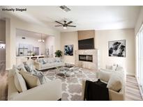 Bright and airy living room featuring modern fireplace and comfortable seating arrangement at 10205 Birch Bluff Ln, Las Vegas, NV 89145