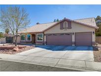 Charming single-story home featuring a tile roof, two-car garage, and low maintenance desert landscaping at 1777 Indian Summer Dr, Las Vegas, NV 89123