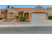 Charming single-story home with a well-maintained yard, neutral color scheme, and a two-car garage at 1925 Hot Oak Ridge St, Las Vegas, NV 89134