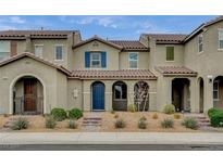 Inviting two-story townhome featuring a well-manicured yard and a classic Mediterranean-style design at 3165 Brynley Ave, Henderson, NV 89044