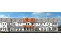 Charming townhome showcasing a Spanish-style facade with a vibrant red-tiled roof and classic arched entryways at 3735 Via Allegro, Henderson, NV 89044