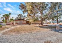 Charming single-story brick home with a large front yard and mature trees at 6635 Laredo St, Las Vegas, NV 89146
