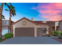 Charming single-story home featuring a multi-car garage and desert landscaping at 8512 Porch Rocker St, Las Vegas, NV 89143