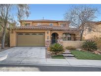 Charming two-story home featuring a tiled roof, desert landscaping, and a two-car garage at 857 White Sparrow St, Henderson, NV 89052