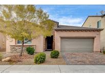 Inviting single-story home showcasing a well-manicured front yard and a two-car garage at 907 Gallery Course Dr, Las Vegas, NV 89148