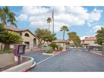Exterior view of a gated community entrance with manicured landscaping and common areas on a clear, sunny day at 2606 S Durango Dr # 287, Las Vegas, NV 89117