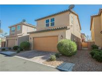 Two-story home featuring a brick driveway and a two-car garage at 3158 Teaderman Walk, Henderson, NV 89044