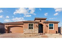 Charming single-story home with desert landscaping, stone accents, and an arched garage entrance at 400 S Jena St, Henderson, NV 89015