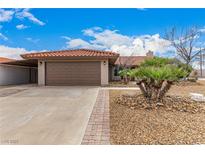 Charming single story home featuring a brown two-car garage and a desert landscape with gravel and a decorative palm at 436 Concord Way, Henderson, NV 89015