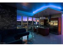 Modern living room with cityscape view, chalkboard accent wall and island kitchen with stainless steel appliances at 4471 Dean Martin Dr # 2101, Las Vegas, NV 89103