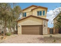 Inviting two-story home featuring a two-car garage and low-maintenance desert landscaping at 6622 Palm Branch St, North Las Vegas, NV 89086