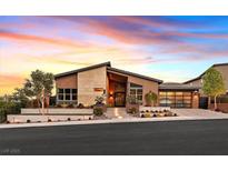 Striking single-story home with modern design, professional landscaping, and a glass-paneled garage at 6690 Interstellar St, Las Vegas, NV 89135