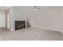 Bright living room features modern flooring, fireplace, and stylish ceiling fan for comfortable living at 6712 Biltmore Garden St, Las Vegas, NV 89149