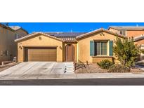 Charming single-story home with a well-maintained front yard and a two-car garage, solar panels and stone landscaping at 6733 Violet Bluff Ct, North Las Vegas, NV 89084