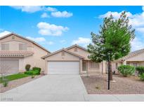 Charming one-story home featuring a well-maintained front yard, two-car garage, and inviting curb appeal at 9020 Crooked Shell Ave, Las Vegas, NV 89143
