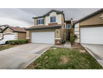 Charming two-story home featuring a two-car garage, well-kept lawn and appealing architectural details at 10311 Birch Bluff Ln, Las Vegas, NV 89145