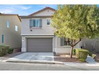 Charming two-story home featuring a neutral color palette, two-car garage, and mature landscaping at 10608 Kennedy Peak Ln, Las Vegas, NV 89166