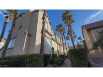Lovely multi-story home with desert landscaping and palm trees under a beautiful blue sky at 1505 Couples St, Las Vegas, NV 89128
