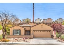 Charming single-story home with well-manicured landscaping and a two-car garage at 2413 Hamonah Dr, Henderson, NV 89044