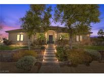 Charming single-story home with manicured front yard and stone walkway leading to the front door at 319 Belfast St, Henderson, NV 89015