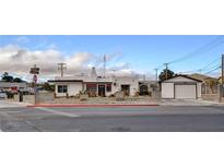 Charming home featuring stucco exterior, brick accents, a detached garage, and xeriscaped yard at 537 Avenue I, Boulder City, NV 89005