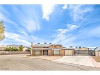 Charming two-story home with desert landscaping, spacious driveway, and secure gated entrance at 5751 E Owens Ave, Las Vegas, NV 89110
