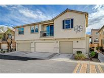 Two-story townhome featuring multiple garage spaces and neutral stucco exterior at 6255 W Arby Ave # 193, Las Vegas, NV 89118